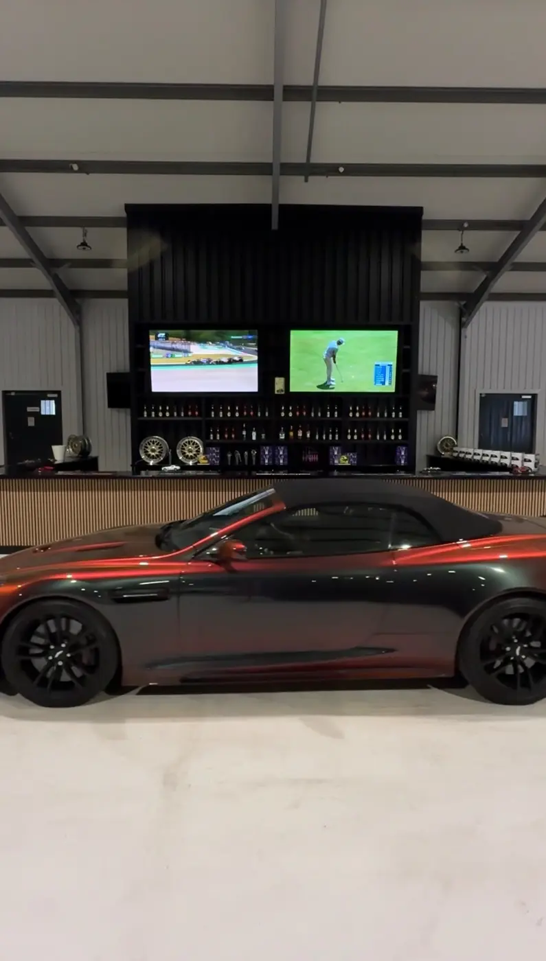 A stored Aston Martin beside the facility customer area