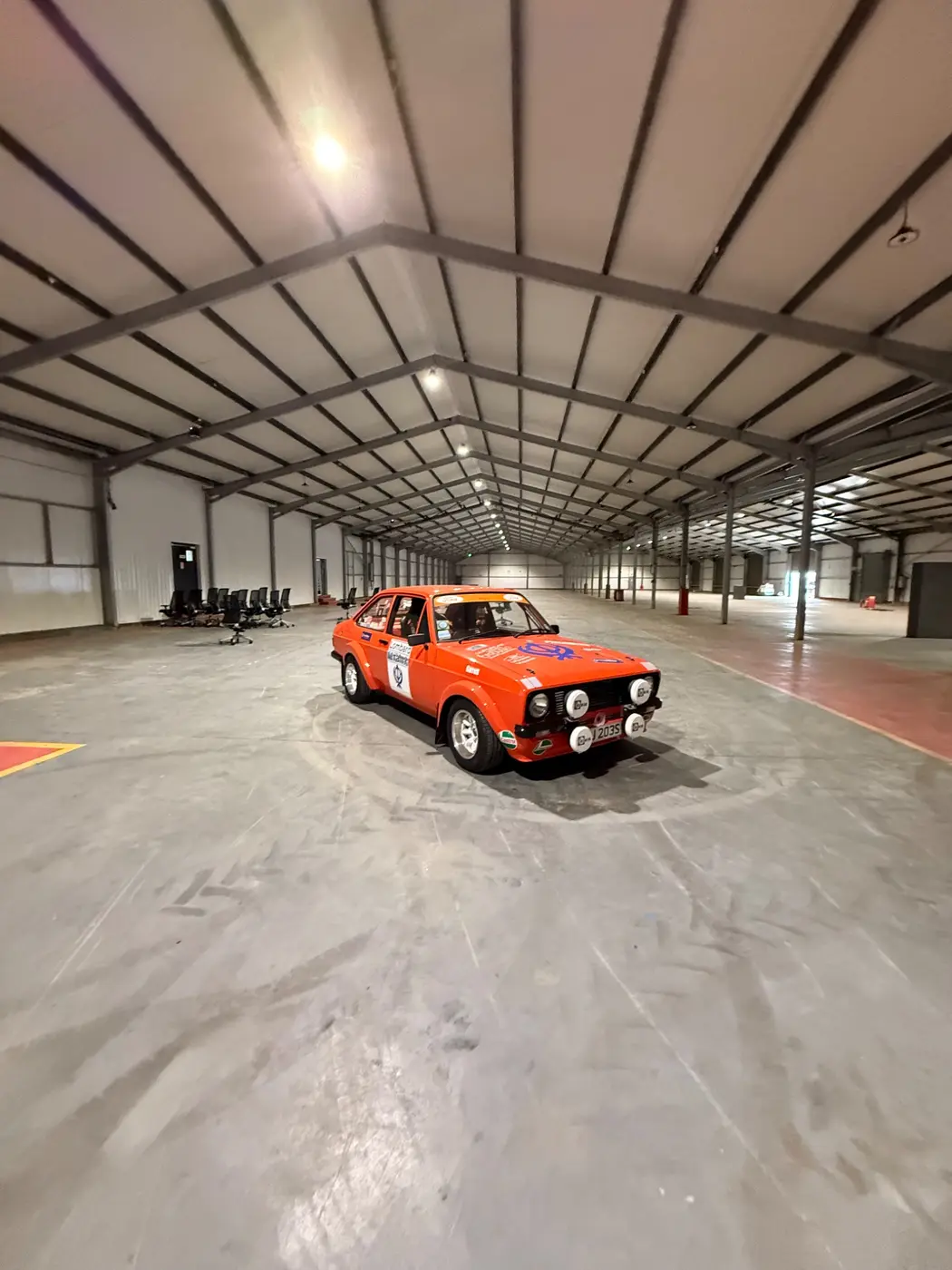 A vehicle within the open indoor storage hall