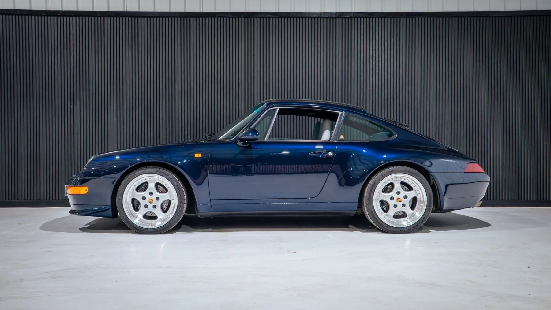 A classic Porsche presented inside the facility